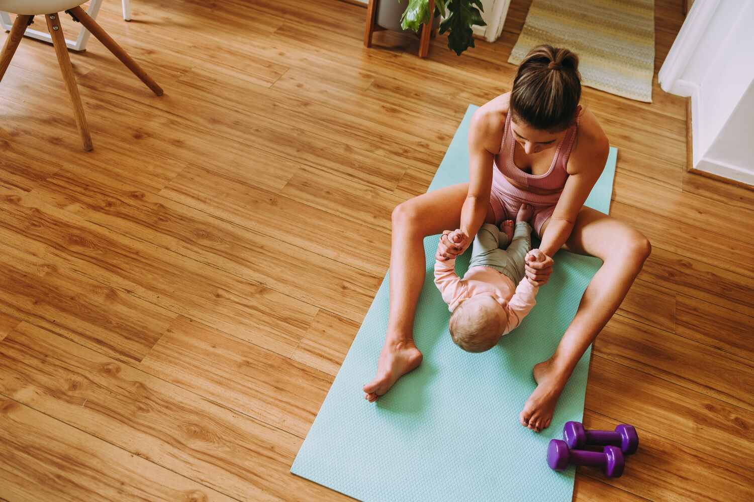 Mom doing situps with baby