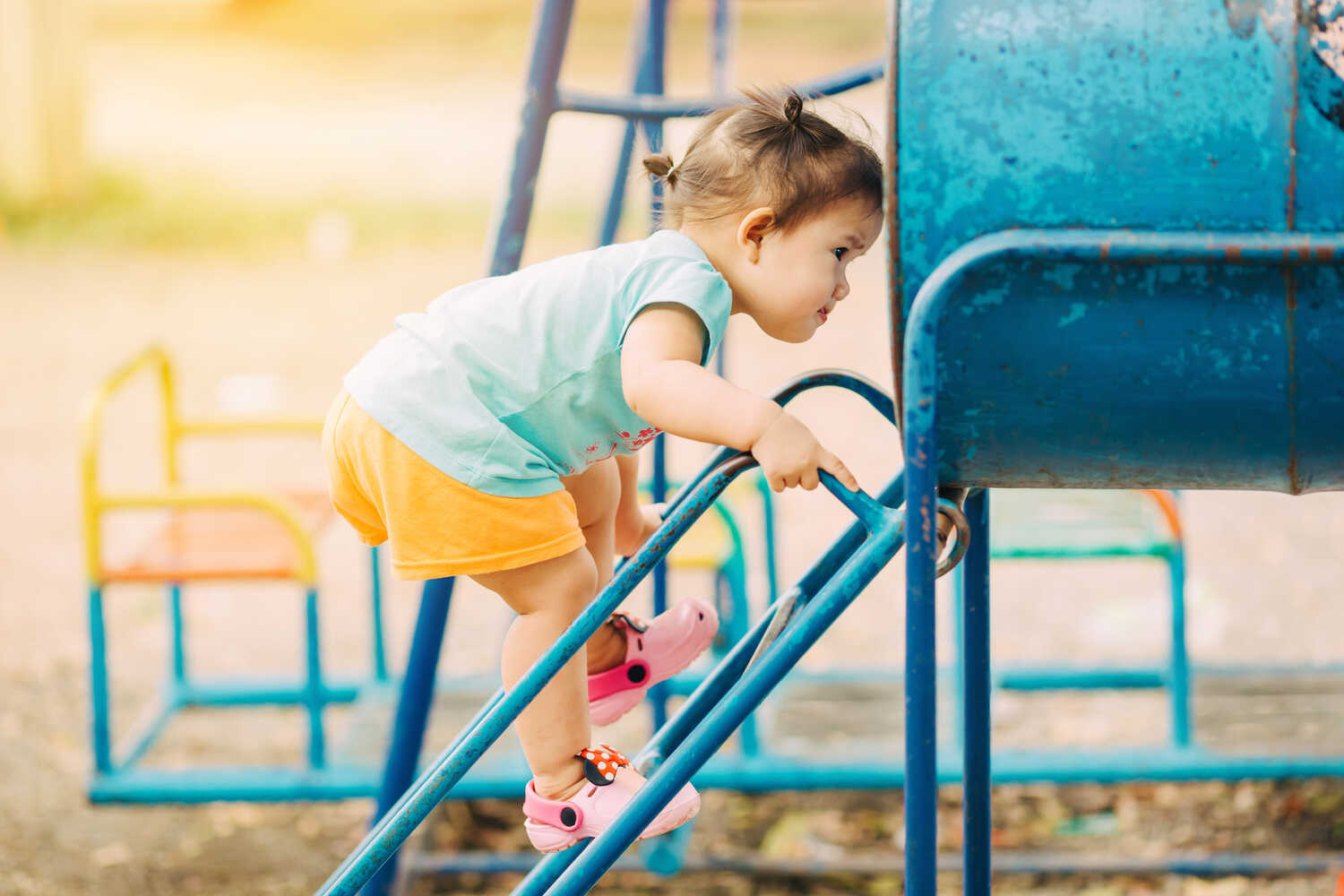 A toddler girl playing in park