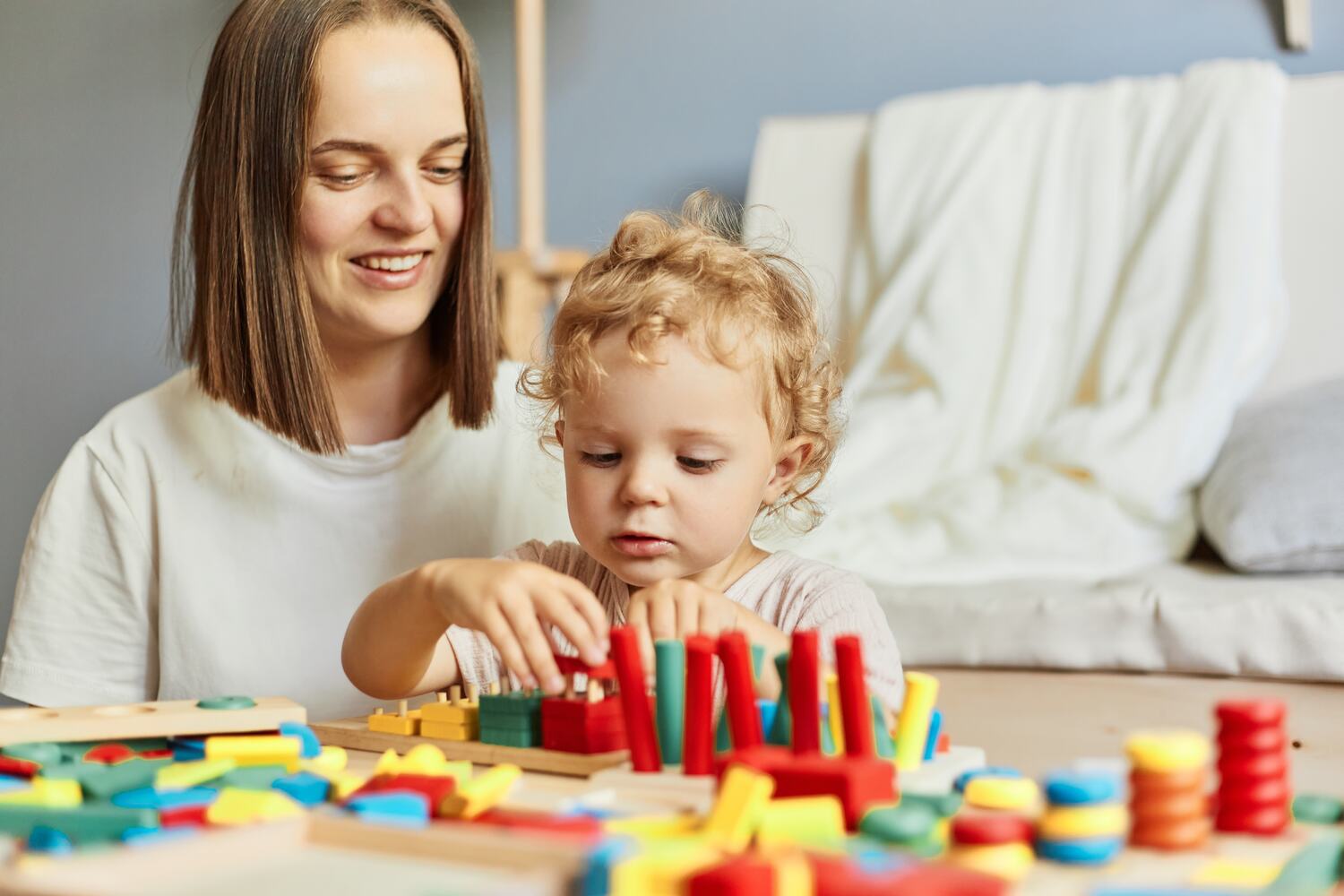 A toddler playing shape sorting game