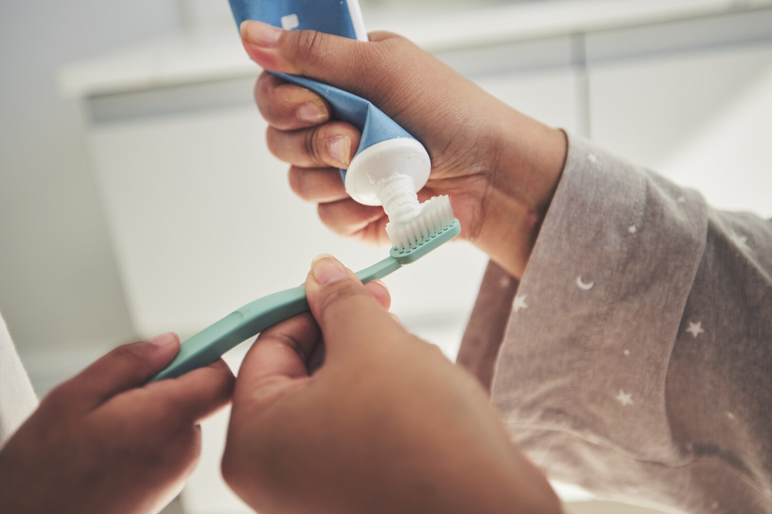 Putting toothpaste on brush