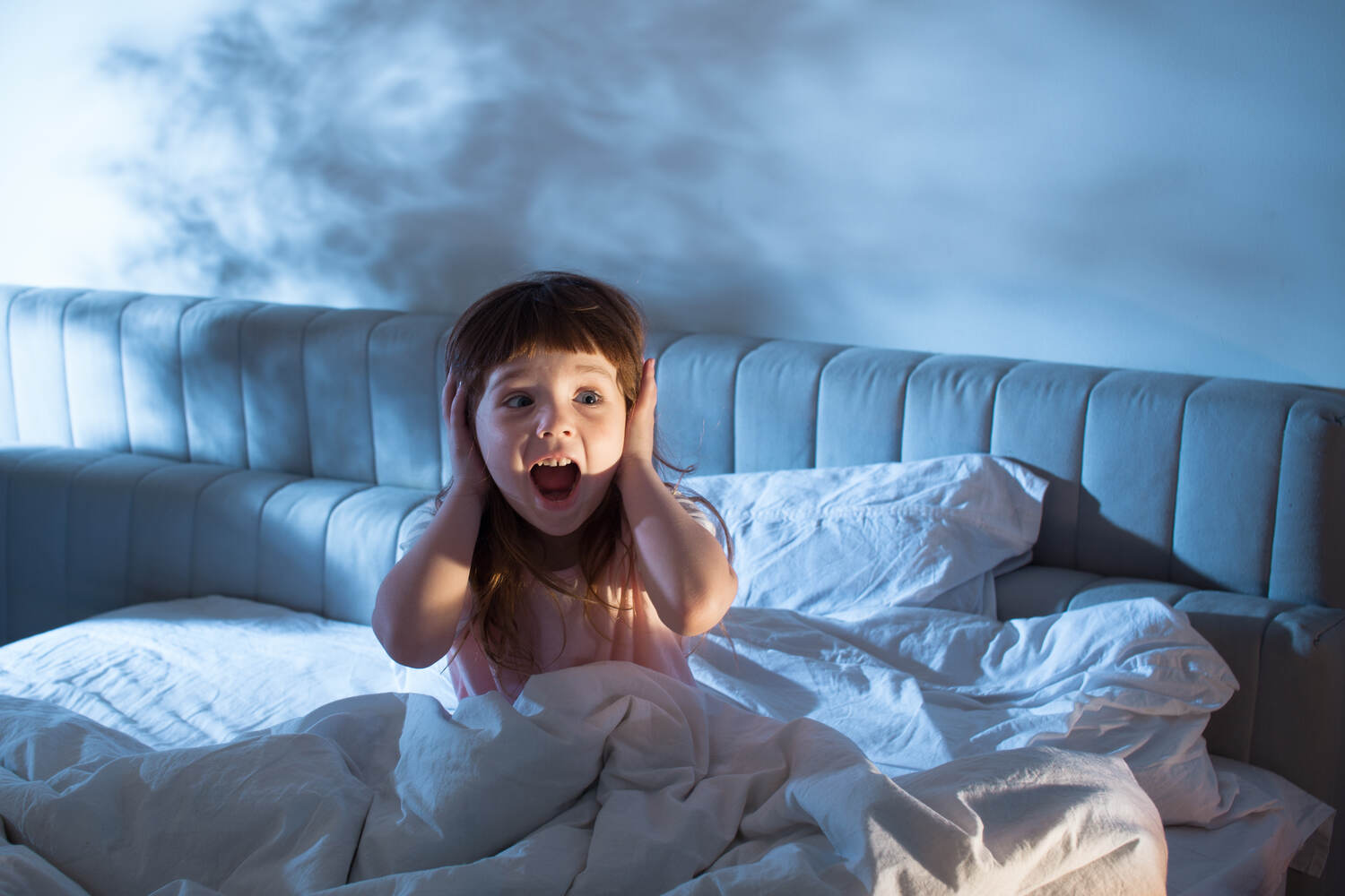 A toddler girl reacting after waking up from sleep