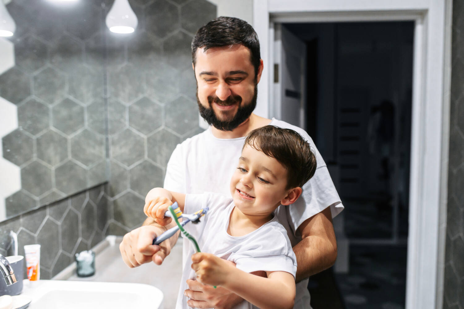 A father and his toddler with toothbrushes