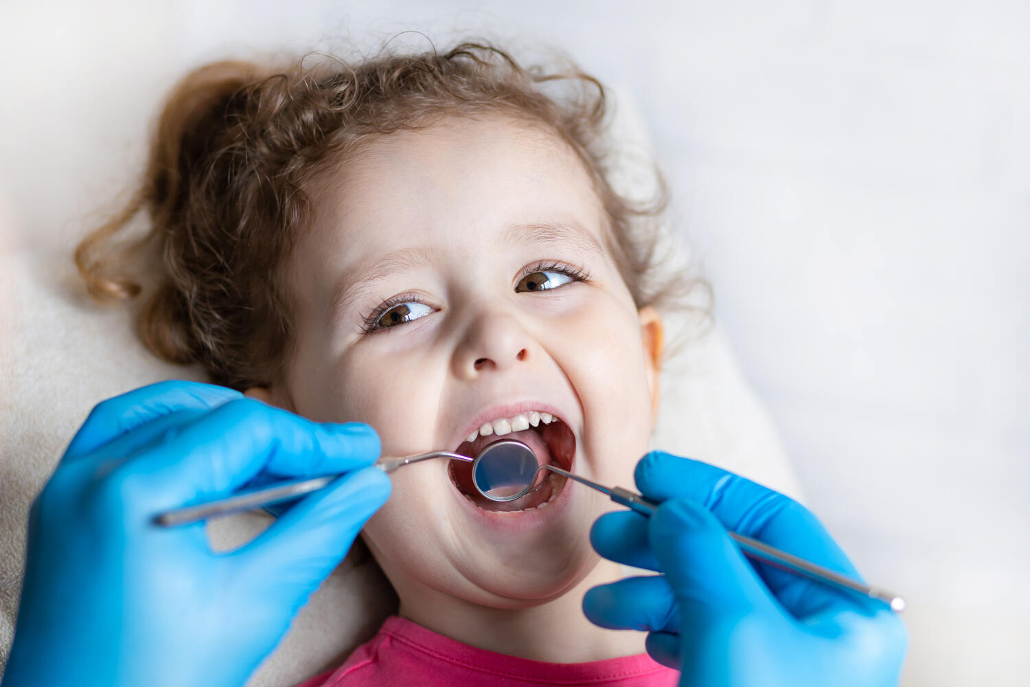 A little girl getting a dental examination