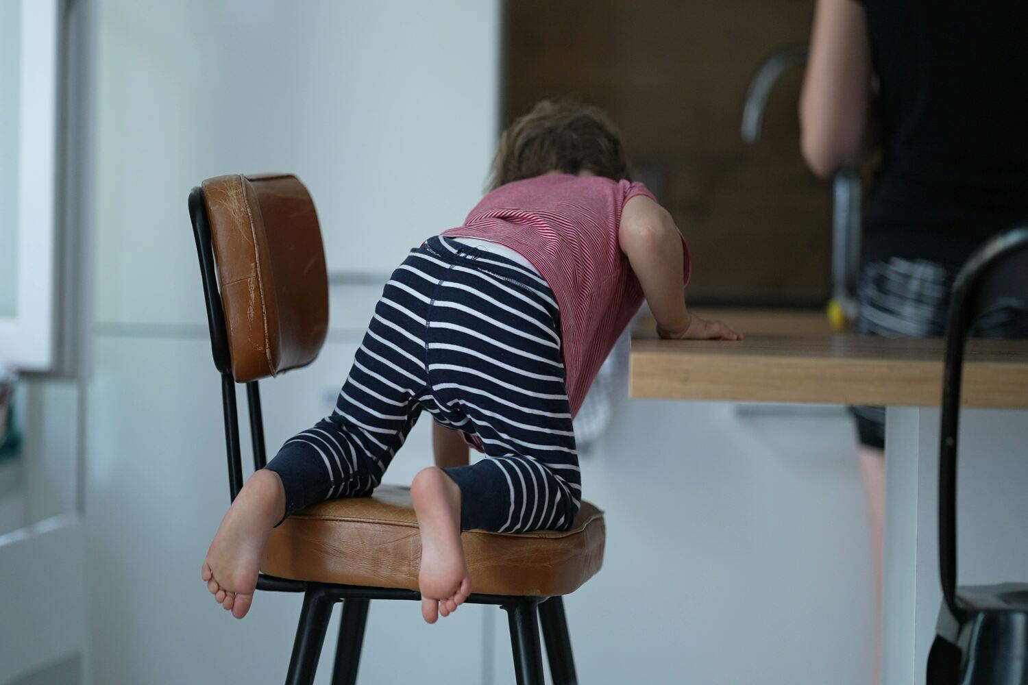 Toddler getting down from chair