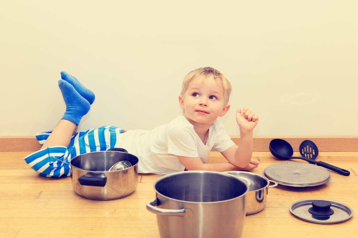 A toddler with utensils